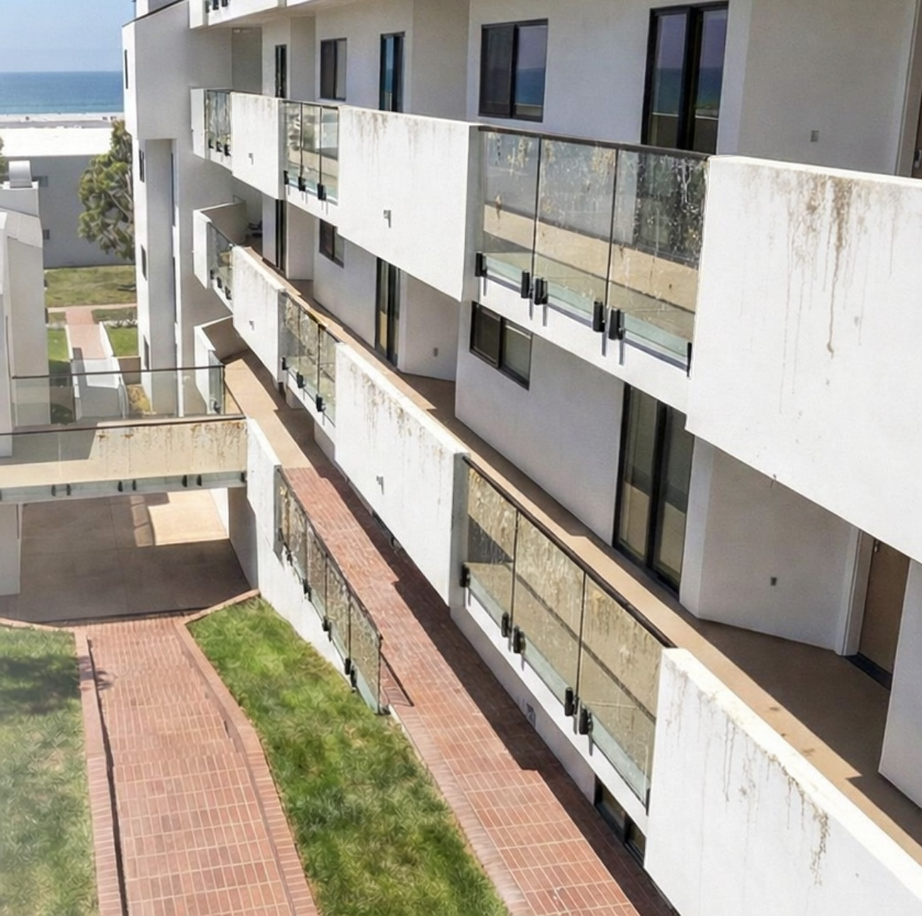 Glass railings showing visible staining and maintenance issues